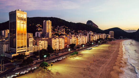 Aerial drone view of Leme Beach in the Copacabana district at sunrise with the iconic Sugarloaf Mountain in the background, UNESCO World Heritage Site, Rio de Janeiro, Brazil, South America - RHPLF25252