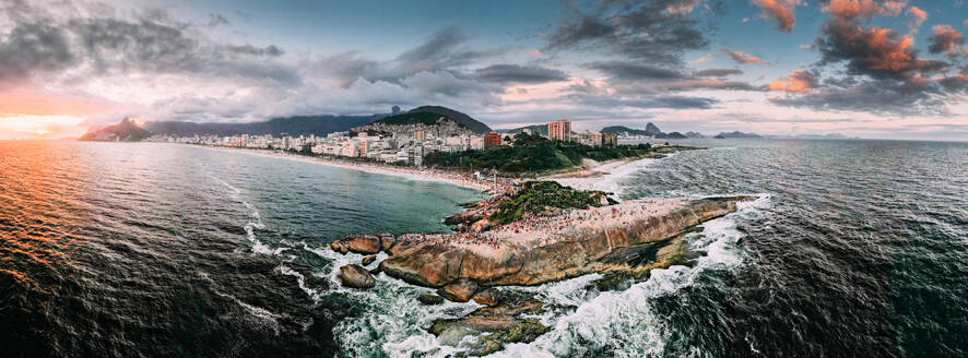 Aerial drone panorama of Ipanema and Copacabana beaches at sunset with Arpoador Rock closest to foreground and Sugarloaf Mountain visible, Rio de Janeiro, Brazil, South America - RHPLF25258