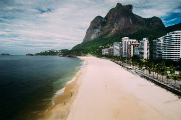 Aerial view of luxurious residential buildings in Sao Conrado, next to Gavea Beach with Pedra da Gavea visible at the far end, Rio de Janeiro, Brazil, South America - RHPLF25261