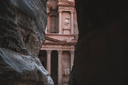 Petra Treasury (El Khazneh) partially hidden, reveals itself at the end of the Siq canyon, Petra, UNESCO World Heritage Site, Jordan, Middle East - RHPLF25284