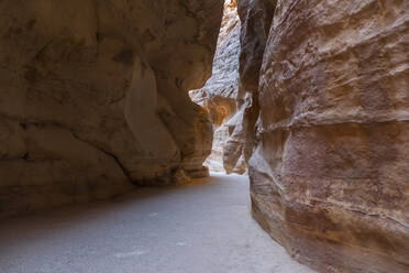 The Siq, a narrow canyon in the mountains, the entrance to the lost city of Petra, Petra, UNESCO World Heritage Site, Jordan, Middle East - RHPLF25285