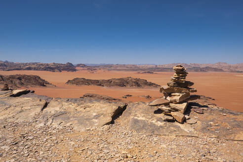 Wadi Rum red desert with some stone stacked in a pile in the foreground, Jordan, Middle East - RHPLF25288