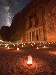 Petra Treasury (El Khazneh) by night illuminated by small lanterns and the Milky Way in the sky, Petra, UNESCO World Heritage Site, Jordan, Middle East - RHPLF25297