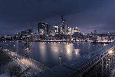 View from Eiserner Steg Bridge across Main River to the skyline of Frankfurt am Main at dawn, Frankfurt am Main, Hesse, Germany, Europe - RHPLF25364