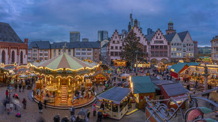 View of carousel and Christmas Market stalls at dusk, Roemerberg Square, Frankfurt am Main, Hesse, Germany, Europe - RHPLF25368