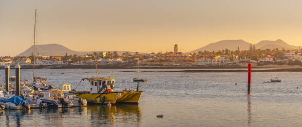 View of harbour boats and Corralejo at sunset, Corralejo, Fuerteventura, Canary Islands, Spain, Atlantic, Europe - RHPLF25398