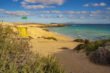 View of beach, surfers and the Atlantic Ocean on a sunny day, Corralejo Natural Park, Fuerteventura, Canary Islands, Spain, Atlantic, Europe - RHPLF25402