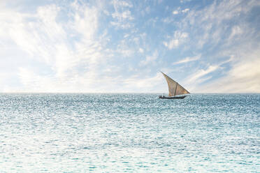 Traditional African dhow sailing in the calm waters of the Indian Ocean, Zanzibar, Tanzania, East Africa, Africa - RHPLF25431