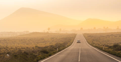 View of road and Tinajo in background, Tinajo, Lanzarote, Las Palmas, Canary Islands, Spain, Atlantic, Europe - RHPLF25511