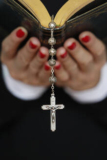 Woman reading the Bible, close up on vintage rosary with crucifix, Faith and religion, France, Europe - RHPLF25561