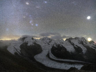 Panoramic of majestic Monte Rosa glacier under the bright stars at night, Gornergrat, Zermatt, canton of Valais, Switzerland, Europe - RHPLF25624