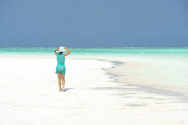 Woman walking on idyllic empty beach, Zanzibar, Tanzania, East Africa, Africa - RHPLF25636