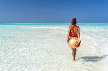 Mid adult woman enjoying walking on a beach, Zanzibar, Tanzania, East Africa, Africa - RHPLF25641