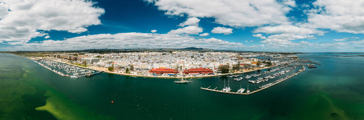 Aerial panoramic drone view of Olhao, officially known as Olhao da Restauracao, a city and municipality in the Algarve region, southern Portugal, Europe - RHPLF25644