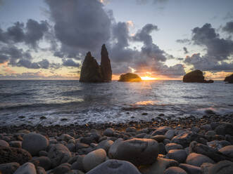 Sunrise below sea stacks from the pebble beach of Bahia da Alagoa, Flores island, Azores islands, Portugal, Atlantic Ocean, Europe - RHPLF25665