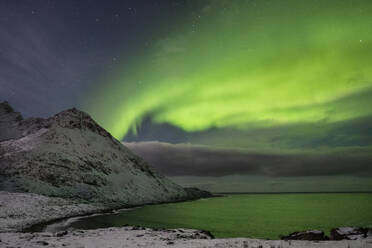 The Aurora Borealis (Northern Lights) over Skoytneset mountain and Mefjorden in winter, near Mefjordvaer, Senja, Troms og Finnmark county, Norway, Scandinavia, Europe - RHPLF25680