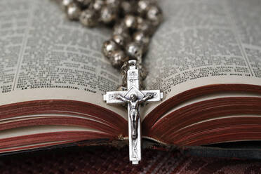 Vintage rosary with crucifix on an open Bible, Christian religious symbol, France, Europe - RHPLF25770