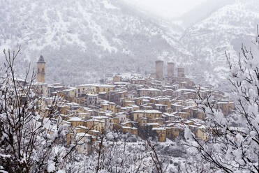 View of the village and the castle of Pacentro under heavy snowfall, Maiella National Park, L'Aquila province, Abruzzo, Italy, Europe - RHPLF25884