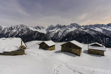 Mountain huts covered with snow at night, Tombal, Soglio, Val Bregaglia, canton of Graubunden, Switzerland, Europe - RHPLF25903