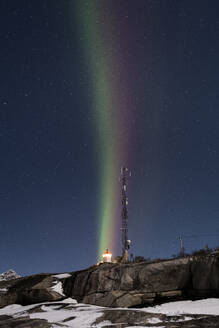 Vertical multi coloured stripes of the Aurora Borealis (Northern Lights) over Tungeneset Lighthouse, Tungeneset, Senja, Troms og Finnmark county, Norway, Scandinavia, Europe - RHPLF25921