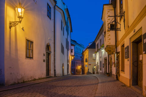 Illuminated street lamp in empty street in historical center at twilight, UNESCO World Heritage Site, Cesky Krumlov, South Bohemian Region, Czech Republic (Czechia), Europe - RHPLF25981
