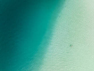 Aerial view of a woman swimming in the Bacalar Lagoon, Bacalar, Quintana Roo, Mexico. - AAEF18311