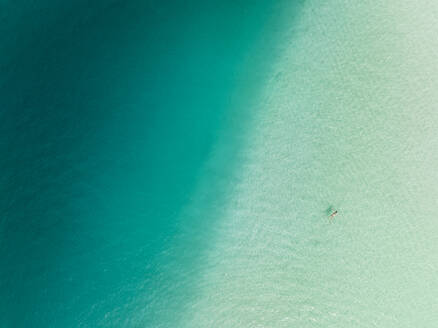 Aerial view of a woman swimming in the Bacalar Lagoon, Bacalar, Quintana Roo, Mexico. - AAEF18311