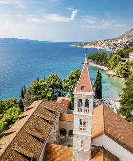 Aerial view of a church along the coast with a small town of Bol, Croatia. - AAEF18351