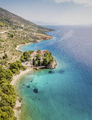 Aerial view of a church along the coast in the small town of Bol, Croatia. - AAEF18352