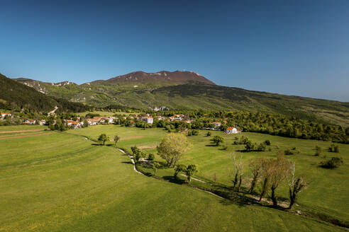 Aerial view of Brest village with Ucka mountain in the background, Central Istria in Croatia. - AAEF18370