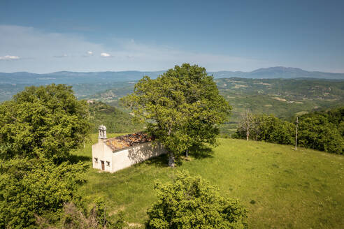 Aerial view of a small church next to the village of Kascerga in central Istria, Croatia. - AAEF18381