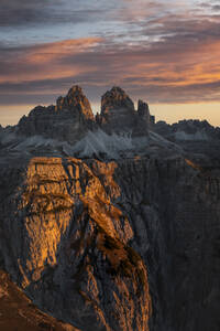 Aerial View of sunrise light at mountain tops of Tre Cime with amazing colours in the clouds, Dolomites, South Tyrol, Italy. - AAEF18413