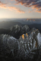 Aerial View of mountain area of Mangart with last golden light hitting the tops, Skala, Naravni spomenik Mangart, Border between Slovenia and Italy. - AAEF18419