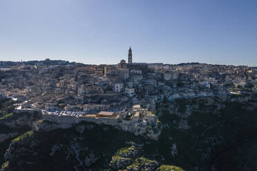 Aerial view of Sassi di Matera at sunlight, an ancient old town along the mountain crest, Matera, Basilicata, Italy. - AAEF18435