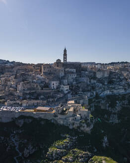 Aerial view of Sassi di Matera at sunlight, an ancient old town along the mountain crest, Matera, Basilicata, Italy. - AAEF18436
