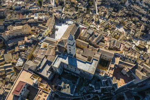 Aerial view of Maria Santissima della Bruna e Sant'Eustachio cathedral in Sassi di Matera, an ancient old town along the mountain crest, Matera, Basilicata, Italy. - AAEF18437