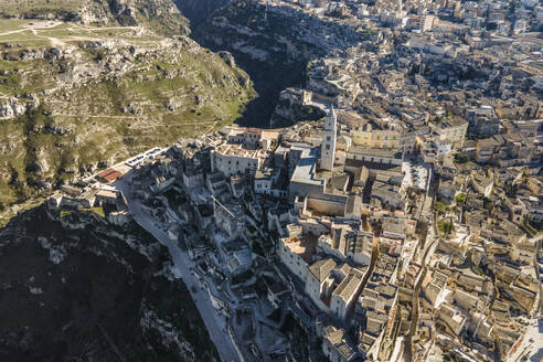 Aerial view of Sassi di Matera at sunlight, an ancient old town along the mountain crest, Matera, Basilicata, Italy. - AAEF18440