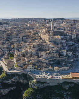 Aerial view of Sassi di Matera at sunlight, an ancient old town along the mountain crest, Matera, Basilicata, Italy. - AAEF18446