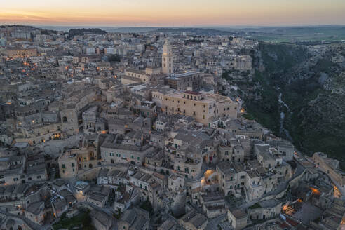 Aerial view of Sassi di Matera at sunset, an ancient old town along the mountain crest, Matera, Basilicata, Italy. - AAEF18448