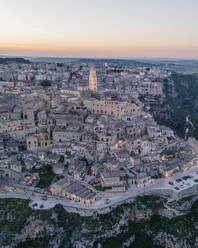 Aerial view of Sassi di Matera at sunset, an ancient old town along the mountain crest, Matera, Basilicata, Italy. - AAEF18449