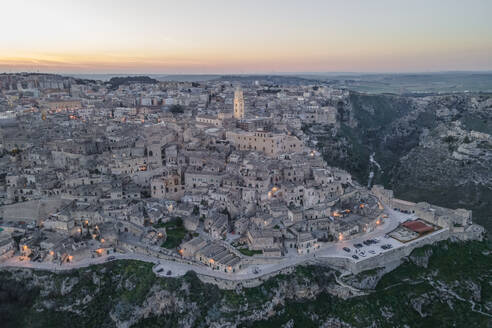 Aerial view of Sassi di Matera at sunset, an ancient old town along the mountain crest, Matera, Basilicata, Italy. - AAEF18450