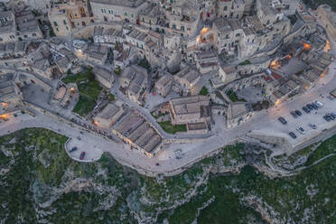 Aerial view of Sassi di Matera at sunset, an ancient old town along the mountain crest, Matera, Basilicata, Italy. - AAEF18452