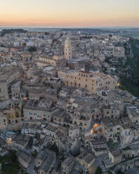 Aerial view of Sassi di Matera at sunset, an ancient old town along the mountain crest, Matera, Basilicata, Italy. - AAEF18453