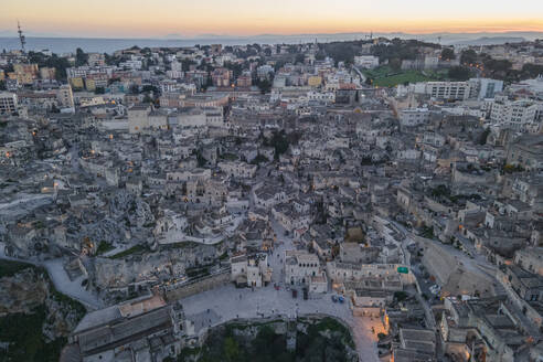 Aerial view of Sassi di Matera at sunset, an ancient old town along the mountain crest, Matera, Basilicata, Italy. - AAEF18511
