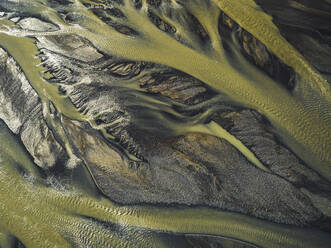 Aerial view of water formation pattern of a river along the coast in Eastern region, Iceland. - AAEF18582