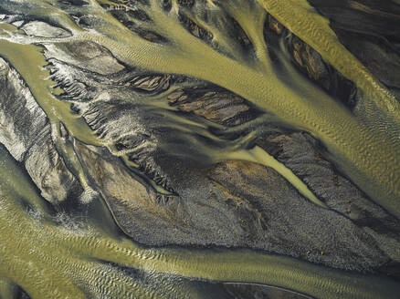 Aerial view of water formation pattern of a river along the coast in Eastern region, Iceland. - AAEF18582