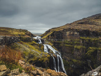 Aerial view of a waterfall with stream in Iceland highlands. - AAEF18588