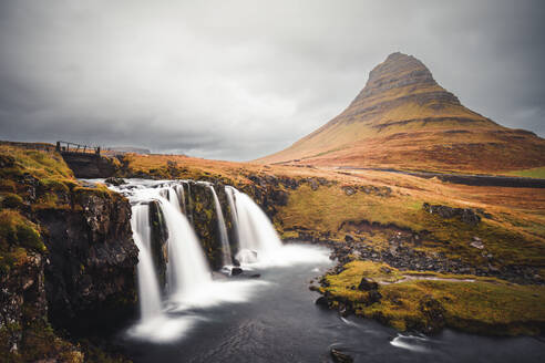 Aerial view of Mount Kirkjufell with waterfall and river in Iceland. - AAEF18590