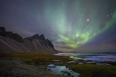 Aerial view of northern lights at Stokksnes bay near the Vestrahorn mountain, Austurland, Iceland. - AAEF18623