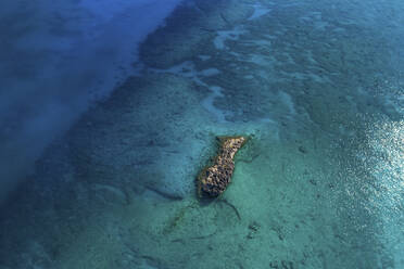 Aerial View of a typical small rocky isle surrounded by clear sea water, Berry Islands, the Bahamas. - AAEF18640